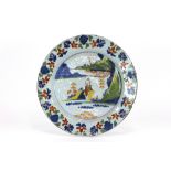 An English delft polychrome charger, mid 18th Century,