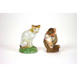 A Chelsea style porcelain model of a cat, seated, (restored),