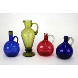 A continental olive tinted glass jug, of baluster form, wrythen moulded, applied raspberry prunts,