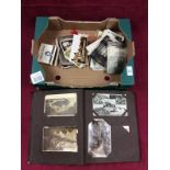 A box containing a postcards album with part contents;