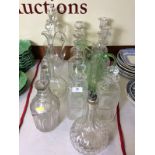 A quantity of 19th Century and later glass decanters and stoppers; ewers; a green glass jug etc.