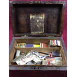 A pine box and contents of cigarette cards and matchboxes