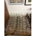 A quantity of mostly modern drinking glasses; a cranberry glass ewer etc.