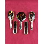 Five tortoiseshell and silver dressing table items