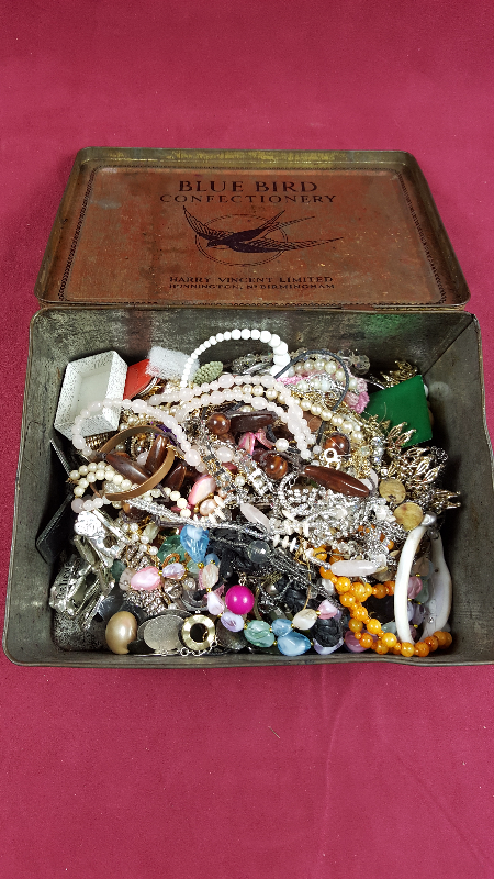 A tin and a box of various costume jewellery