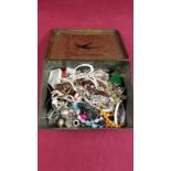 A tin and a box of various costume jewellery