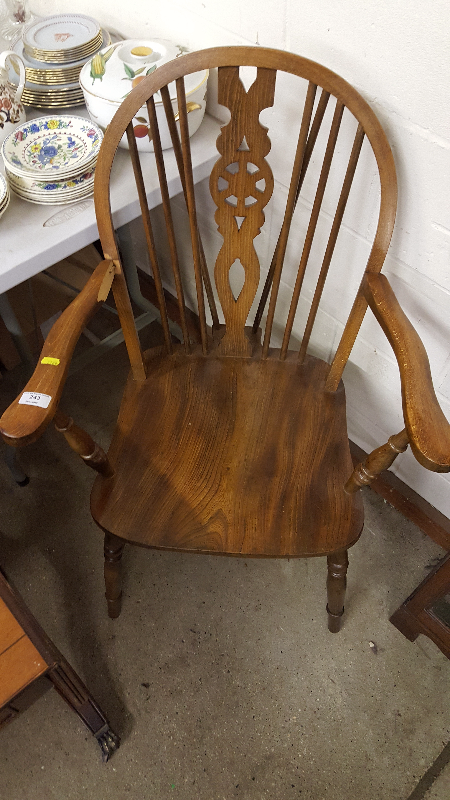 An elm seated stick and wheelback elbow chair