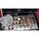 A tin and contents of various coins and bank notes