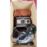 A box containing three vintage cameras