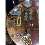 A quantity of various metalware to include two horse brasses; a pair of silver plated candlesticks;