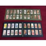 A collection of various glass marbles and three cigarette card albums and contents