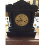 A late Victorian ebonised two hole mantel clock