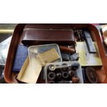 A suitcase containing lighters, cuff-links, coinage,