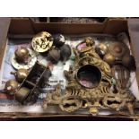 A box containing a gilt metal clock case and various parts