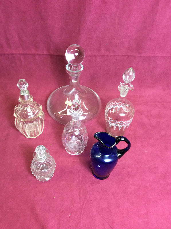 A blue glass jug; four various glass decanters and stoppers,