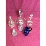 A blue glass jug; four various glass decanters and stoppers,