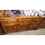 A modern pine sideboard fitted three drawers