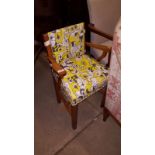 An oak framed and upholstered child's chair