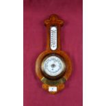 An early 20th Century mahogany and inlaid aneroid barometer with brass presentation plaque