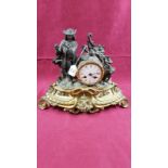 A late 19th Century French spelter two hole mantel clock mounted with a figure