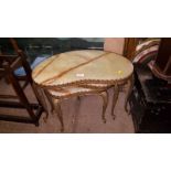 A nest of three onyx and brass occasional tables