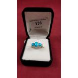 A sterling silver turquoise and diamond set ring