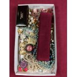 A tray of various costume jewellery, bead necklaces, ear-rings etc.