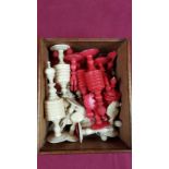 A natural and stained ivory chess set contained in wooden box