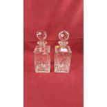 A pair of cut glass decanters and stoppers