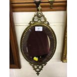 A brass framed and bevel edged mirror