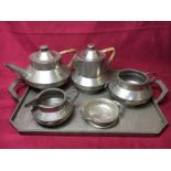 A pewter spot hammered teaset with two handled tray and preserve pot