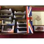 A box containing die-cast toy cars and a Bugatti Owner's Club badge