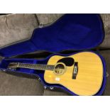 A Jim Deacon twelve string acoustic guitar with carrying case