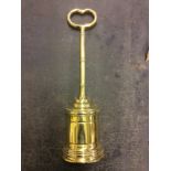 A heavy brass doorstop