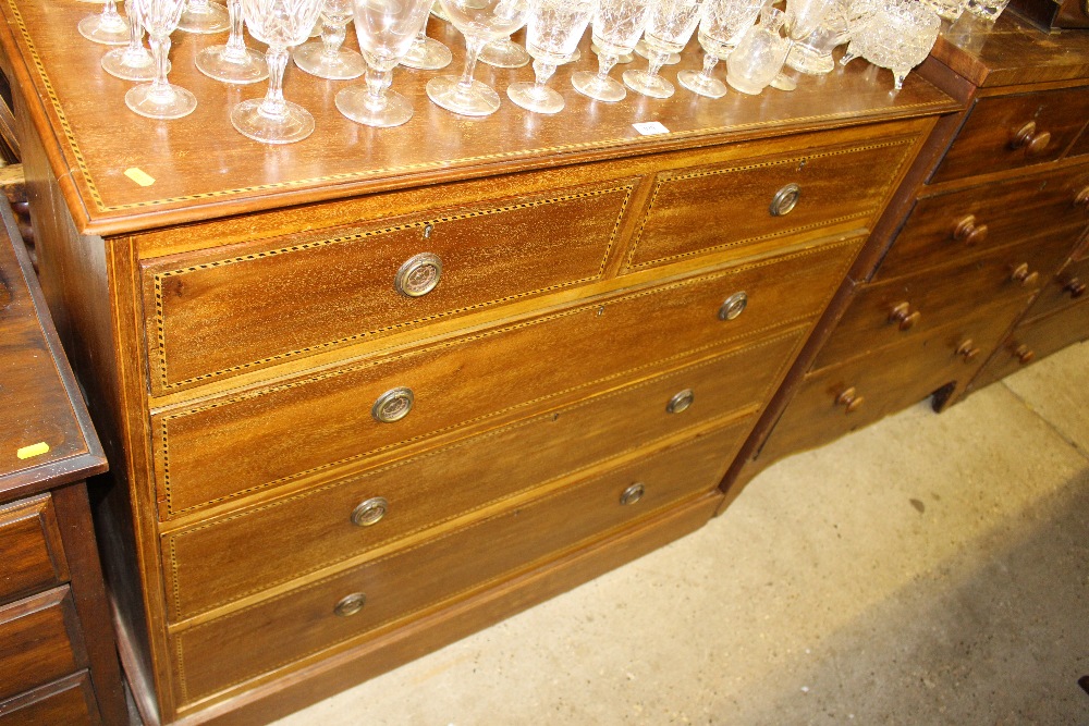 An Edwardian mahogany and chequer strung chest fit