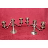 A pair of silver plated three branch candelabra