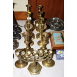 Six pairs of various brass candlesticks and a bras