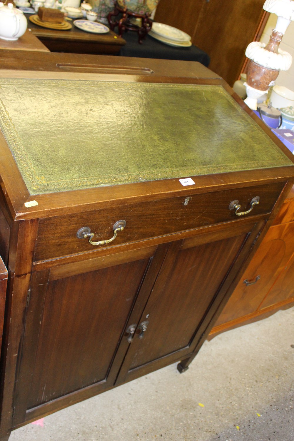 A mahogany and leather topped clerk's desk fitted