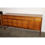 A long teak G-plan design sideboard, the interior shelves enclosed by four panelled doors beneath