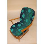 An Ercol armchair, with modern brightly coloured squab cushions