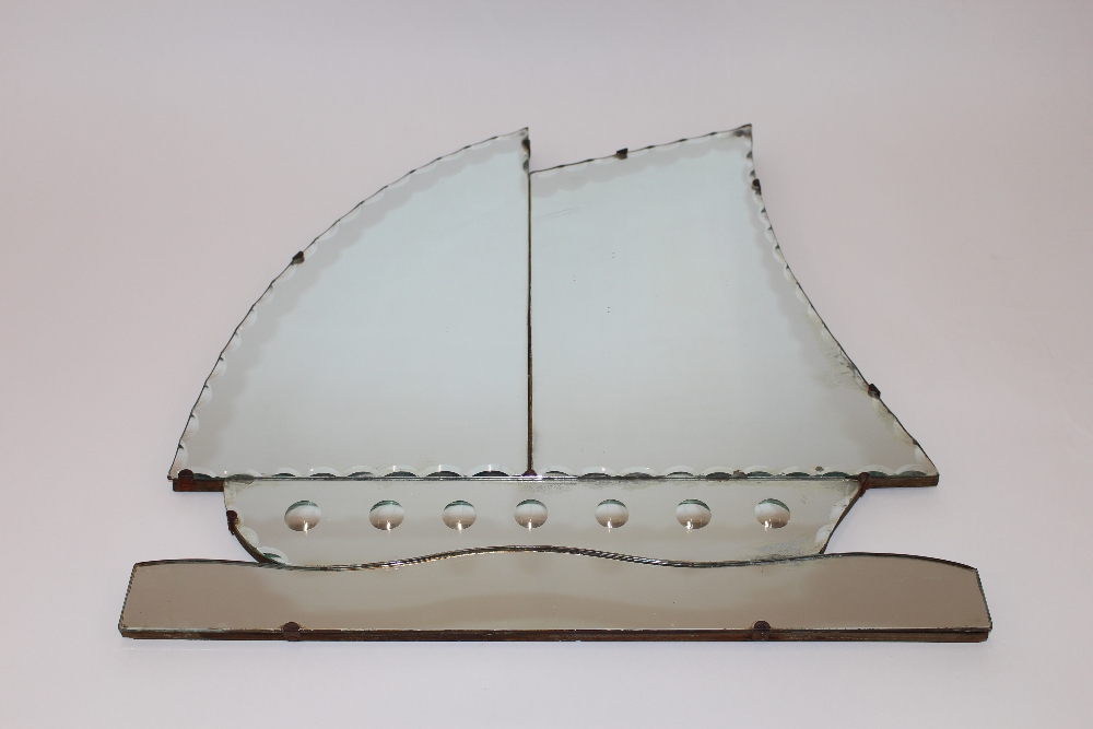 An Art Deco frameless bevel edged wall mirror in the form of a sailing ship, 51cm x 52cm overall