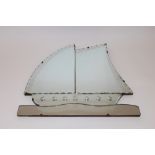 An Art Deco frameless bevel edged wall mirror in the form of a sailing ship, 51cm x 52cm overall