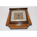 An Art Deco mahogany, walnut and satinwood cross banded barometer with presentation inscription