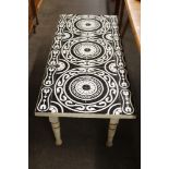 A painted low occasional table, with black and white tile top, 121cm