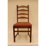 A set of four Ercol "Golden Dawn" ladder back dining chairs