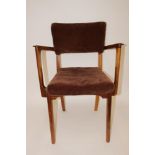 A 1950's/60's designer elbow chair, raised on shaped front supports, upholstered in brown cord