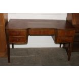 A 1930's Danish walnut kneehole writing desk fitted five drawers, raised on square section supports,