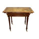 A late Victorian walnut writing table, the leather inset top above a single drawer raised on