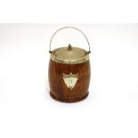 An oak and plate mounted biscuit barrel with swing handle