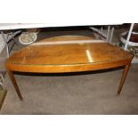 An Art Deco walnut coffee table, of demi-lune shape raised on rounded tapering supports, 120cm